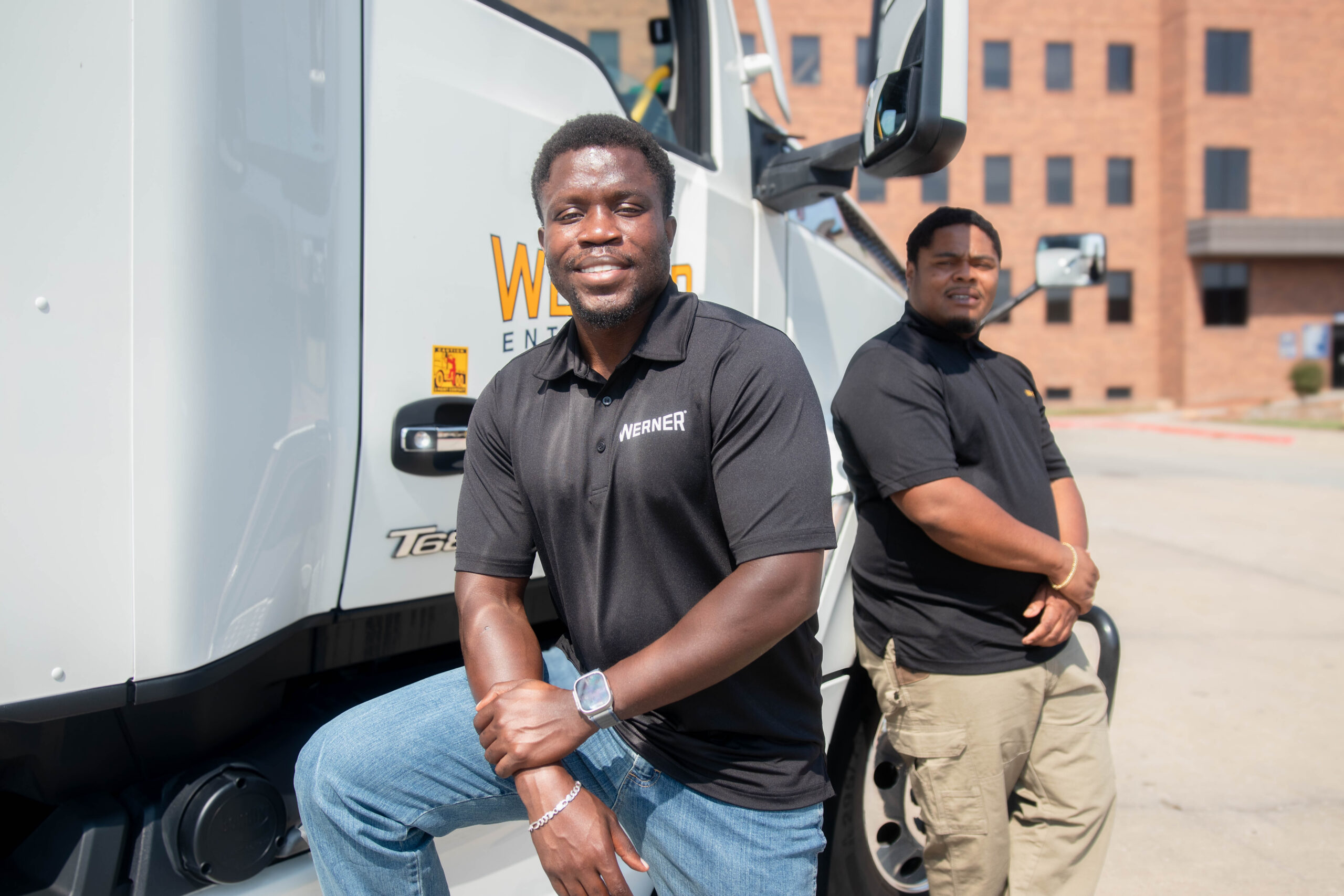 Werner Drivers truck drivers standing next to Werner truck